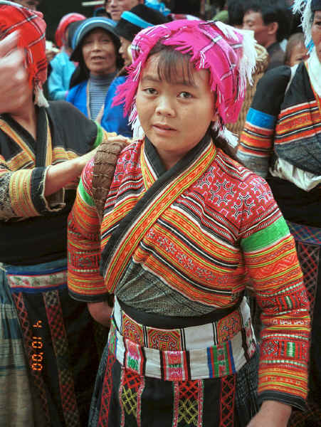 Flower Miao woman from a village in Zhu Chang township bringing her textiles to sell in De Wo market, De Wo township, Longlin county, Guangxi province, South West China 0010f29.jpg