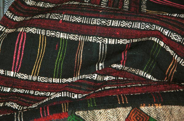 Detail of Southern White Thai skirt purchased in Ban Lac village in the Mai Chau district, Hoa Binh (Ha Son Binh) Province, Vietnam.  Supplementary weft, embroidered thin vertical stripes, embroidered hem. 9511A35E